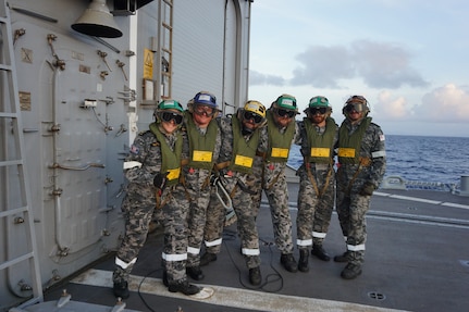 The flight deck crew of the Royal Australian Navy guided-missile frigate HMAS Melbourne (FFG 05) chock and chain an MH-60S Sea Hawk helicopter, assigned to the "Island Knights" of Helicopter Sea Combat Squadron (HSC) 25 to Melbourne’s flight deck. HSC-25 provides a multi-mission rotary wing capability for units in the U.S. 7th Fleet area of operations and maintains a Guam-based 24-hour search-and-rescue and medical evacuation capability, directly supporting U.S. Coast Guard and Joint Region Marianas. HSC-25 is the Navy’s only forward-deployed MH-60S expeditionary squadron.