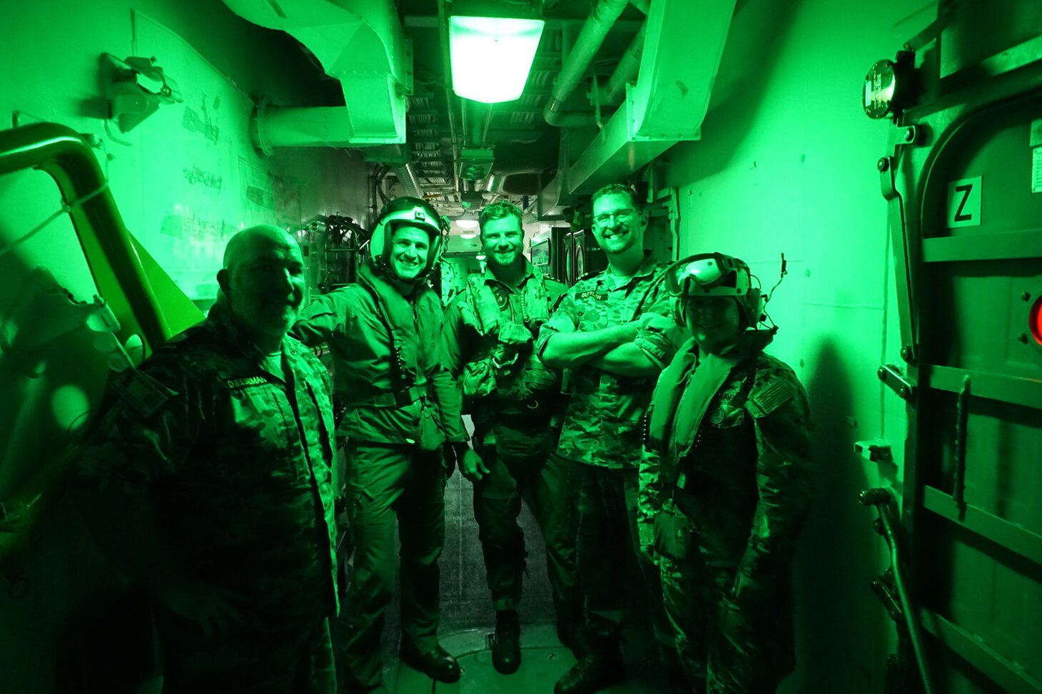 The flight deck crew of the Royal Australian Navy guided-missile frigate HMAS Melbourne (FFG 05) gather for a photo before last take-off of the day by an MH-60S Sea Hawk helicopter, assigned to the "Island Knights" of Helicopter Sea Combat Squadron (HSC) 25. HSC-25 provides a multi-mission rotary wing capability for units in the U.S. 7th Fleet area of operations and maintains a Guam-based 24-hour search-and-rescue and medical evacuation capability, directly supporting U.S. Coast Guard and Joint Region Marianas. HSC-25 is the Navy’s only forward-deployed MH-60S expeditionary squadron.