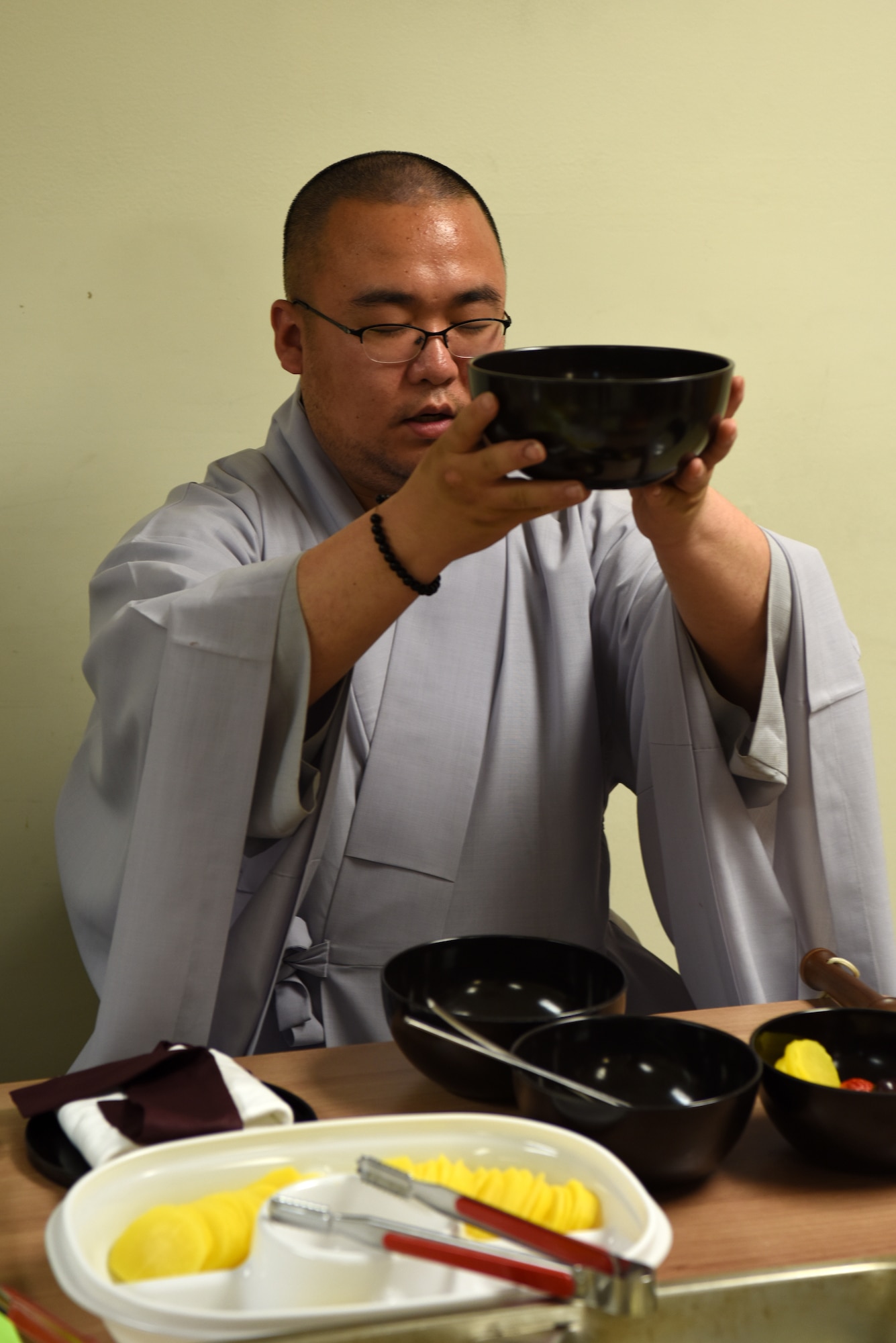 Republic of Korea Air Force Capt. Sungcheol Lee, 38th Fighter Group chaplain, recites a prayer before eating during a Buddhist immersion course at Kunsan Air Base, Republic of Korea, April 11, 2019. The meal consisted of rice, soup and sides each placed in their own bowl so Airmen could experience the flavors of the individual dishes. (U.S. Air Force photo by Staff Sgt. Joshua Edwards)