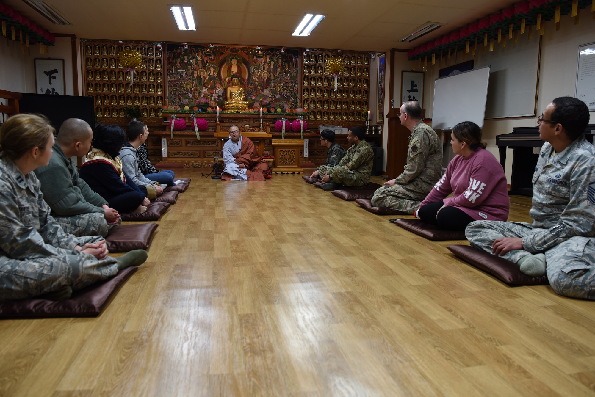 Republic of Korea Air Force Capt. Sungcheol Lee, 38th Fighter Group chaplain, instructs U.S. and ROKAF Airmen in meditation at Kunsan Air Base, Republic of Korea, April 11, 2019. Chaplains sponsored a joint two-day course including guided meditation, a traditional meal, learning the basic history of Buddhism, and temple visits. (U.S. Air Force photo by Staff Sgt. Joshua Edwards)