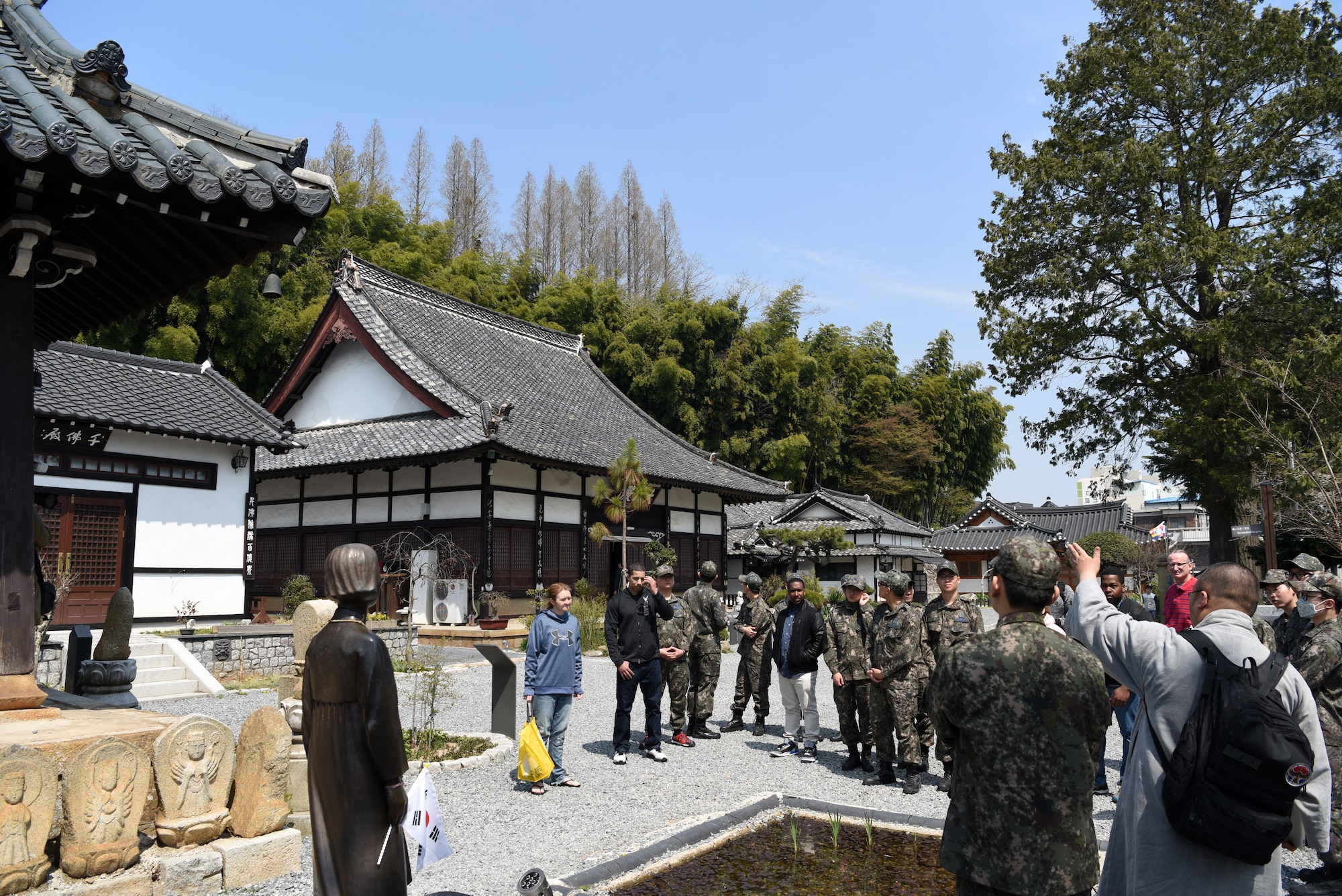 Republic of Korea Air Force Capt. Sungcheol Lee, 38th Fighter Group chaplain, talks about the differences between Japanese and Korean Buddhist temples at Dongguksa Temple in Gunsan City, Republic of Korea, April 13, 2019. Lee explained that the Japanese architectural style shows wood in a more natural state, while Korean style features colorful designs on the wood. (U.S. Air Force photo by Staff Sgt. Joshua Edwards)