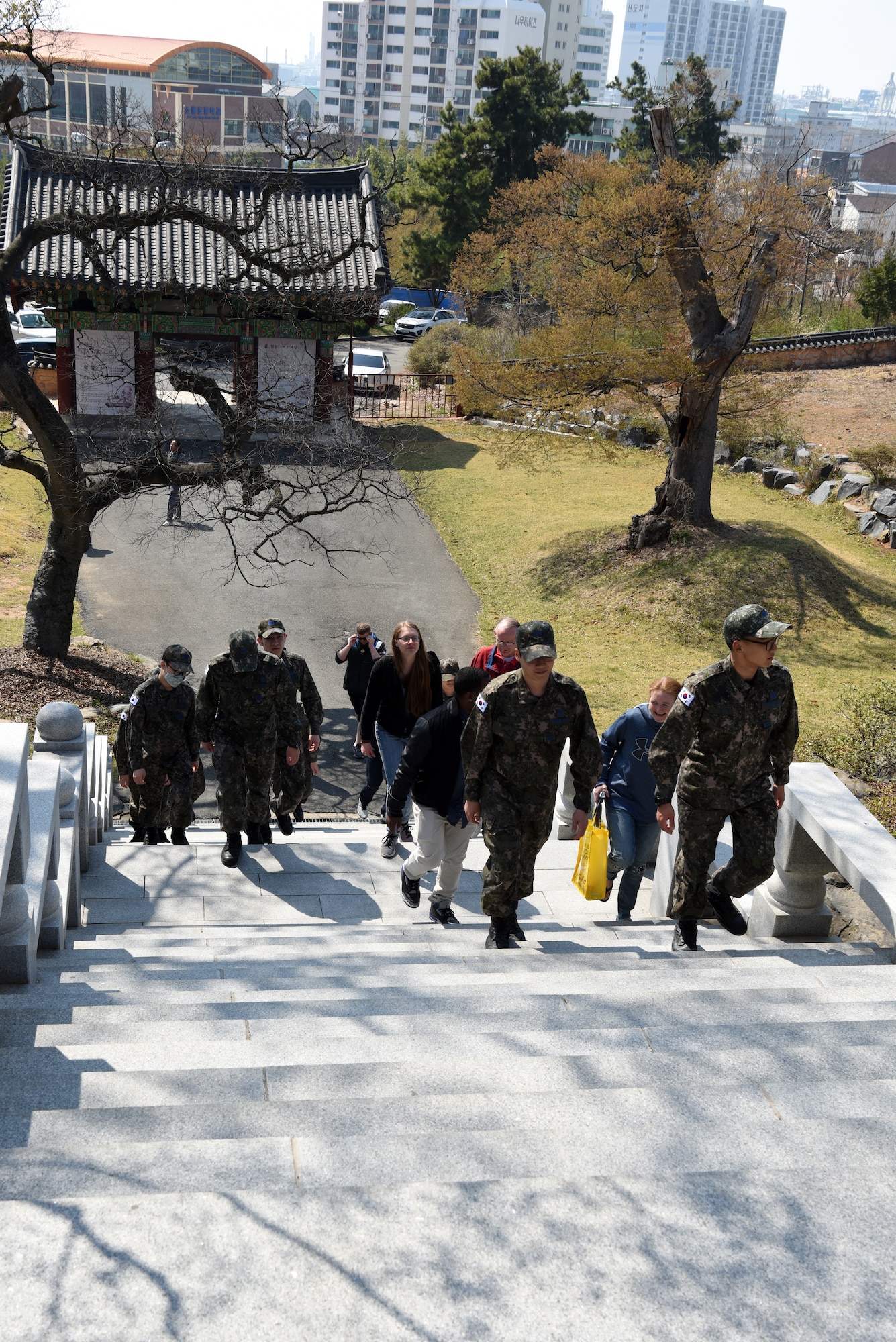 U.S. Air Force and Republic of Korea Air Force Airmen climb a set of stairs to Eunjeok Temple in Gunsan City, Republic of Korea, April 13, 2019. A ROKAF chaplain took Airman around to visit two different styles of Buddhist temples in the city during a two-day immersion course. (U.S. Air Force photo by Staff Sgt. Joshua Edwards)