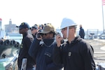 Ensign Ashley Harris and Ensign David Joubert stand watch while getting underway from Piraeus
