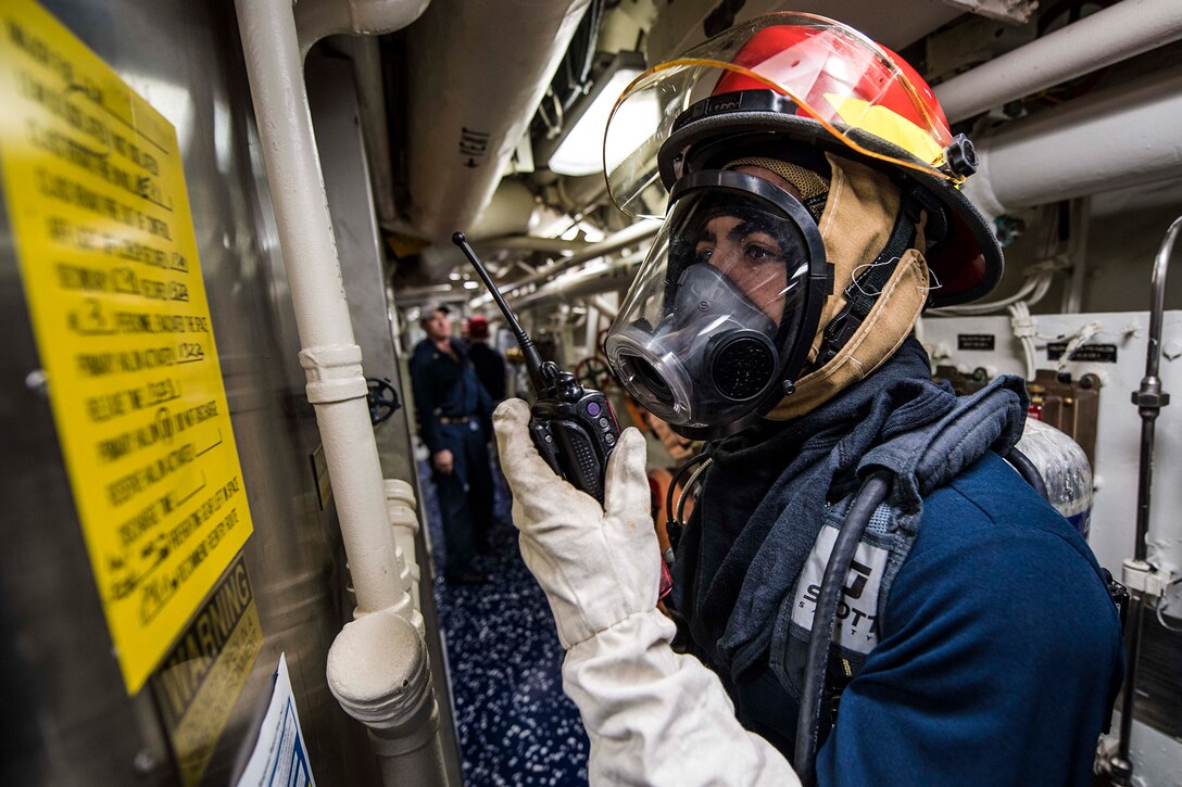 A sailor calls in a report during a drill.