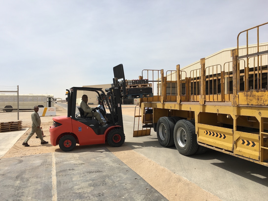 Contractors load of lead acid batteries for their journey from Thumrait Air Base to a recycling facility in Oman.