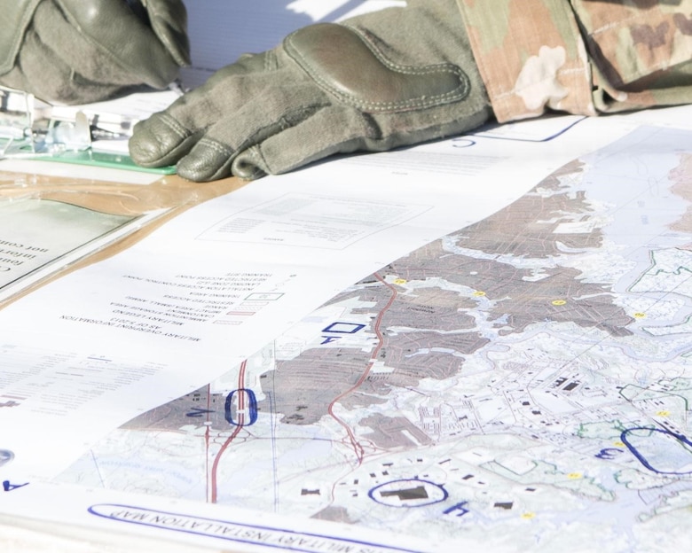 A Soldier studies the layout of a map for the individual task training portion of the competition in Fort Eustis’ 128th Aviation Field at Joint Base Langley-Eustis April 11, 2019. The Soldiers ITT lasted over the course of four hours testing various skills of the Soldiers. (U.S. Air Force Photo by Airman 1st Class Marcus M. Bullock)