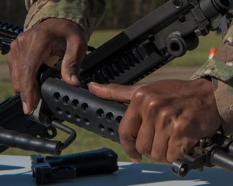 A Soldier disassembles a rifle during the NCO/Soldier of the Year competition in Fort Eustis’ 128 Aviation Field at Joint Base Langley-Eustis, April 11, 2019. The soldiers had to disassemble their rifle then reassemble their rifle as quickly as possible. (U.S. Air Force Photo by Airman 1st Class Marcus M. Bullock)