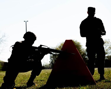 A soldier takes cover at an obstacle during an exercise during the NCO/Soldier of the Year competition in Fort Eustis’ 128th Aviation Field at Joint Base Langley-Eustis, Virginia, April 11, 2019. (U.S. Air Force Photo by Airman 1st Class Marcus M. Bullock)