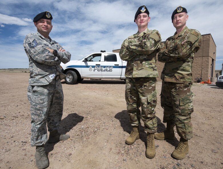 Tech. Sgt. Jason Kadisak, 50th Security Forces Squadron standards and evaluation noncommissioned officer in charge, left, Staff Sgt. Chances Dobbins, 50th SFS standards and evaluation evaluator, middle, and Senior Airman Cody Bilgers, 50th SFS standards and evaluation evaluator,right, stand ready at the 50th SFS headquarters at Schriever Air Force Base, Colorado, April 16, 2019. The flight’s evaluations determine a Defender’s knowledge of their mission, while reviewing methods in place to identify future change and innovation. (U.S. Air Force photo by Staff Sgt. Matthew Coleman-Foster)