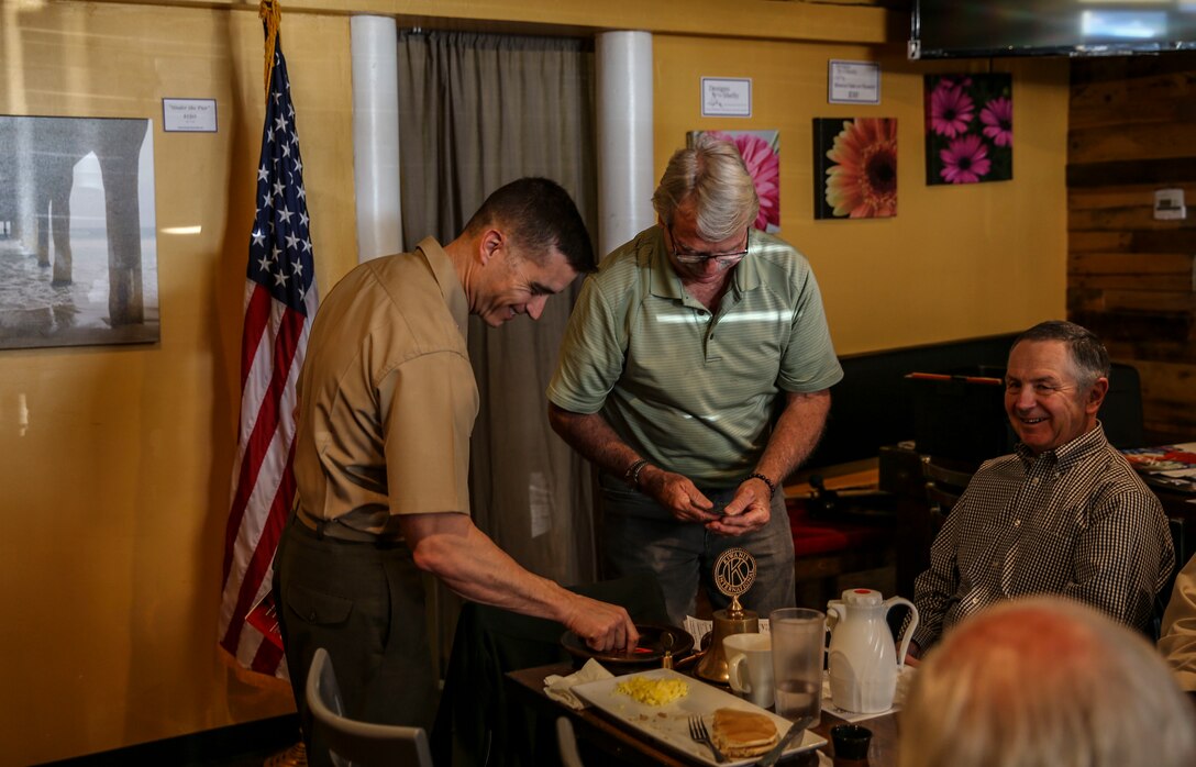 Col. Charles B. Dockery, commanding officer of Marine Corps Air Station Miramar, receives a gift from Rich Orr, the president of Kiwanis Club of Tierrasanta in San Diego, April 17. The Kiwanis Club of Tierrasanta invited Dockery to breakfast to discuss the overview of MCAS Miramar and the Marine Corps’ current priorities. (U.S. Marine Corps photo by Sgt. Sarah Ralph)