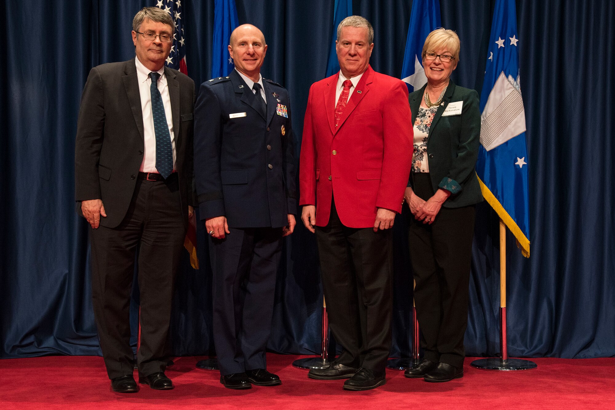DAYTON, Ohio – David Hills (red jacket) received the 2018 Director’s Award for Volunteer of the Year for his dedication and excellence in serving the National Museum of the U.S. Air Force. (from left to right) Museum Director David Tillotson III, Maj. Gen. Carl E. Schaefer Deputy Commander, Air Force Materiel Command, Volunteer David Hills, and Air Force Museum Foundation Board of Trustees President Col.(Ret.) Susan E. Richardson. (U.S. Air Force photo)