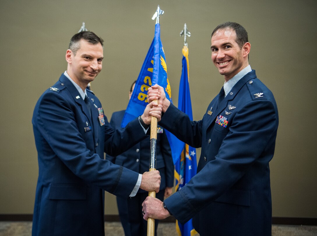 Newly promoted, Col. Christopher Spinelli, right, receives the 932nd Airlift Wing Medical Squadron guidon from Col. Christopher Matlack, Mar. 2, 2019, Scott Air Force Base, Illinois, during the second of two Assumption of Command ceremonies held that day. (U.S. Air Force photo by Master Sgt. Christopher Parr)