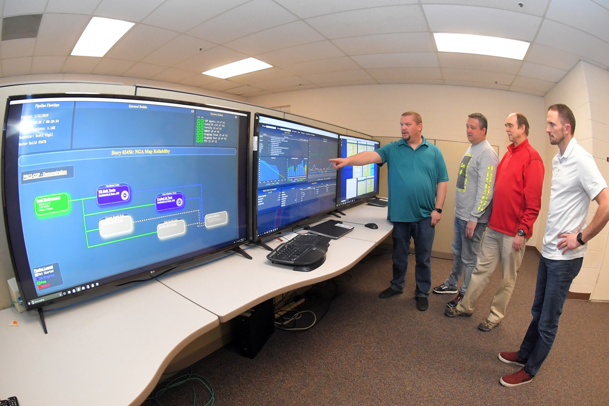 (Left to right) Carl Stucki and Scott Vigil, project directors, David L. Jolley, director, and Brent VanDerMeide, flight director, 517th Software Engineering Squadron, review data March 25, 2019, at Hill Air Force Base, Utah. Software developers in the 517th SWES have developed a new workflow system and software development methodology to significantly reduce the time it takes to deliver software to customers.  (U.S. Air Force photo by Todd Cromar)