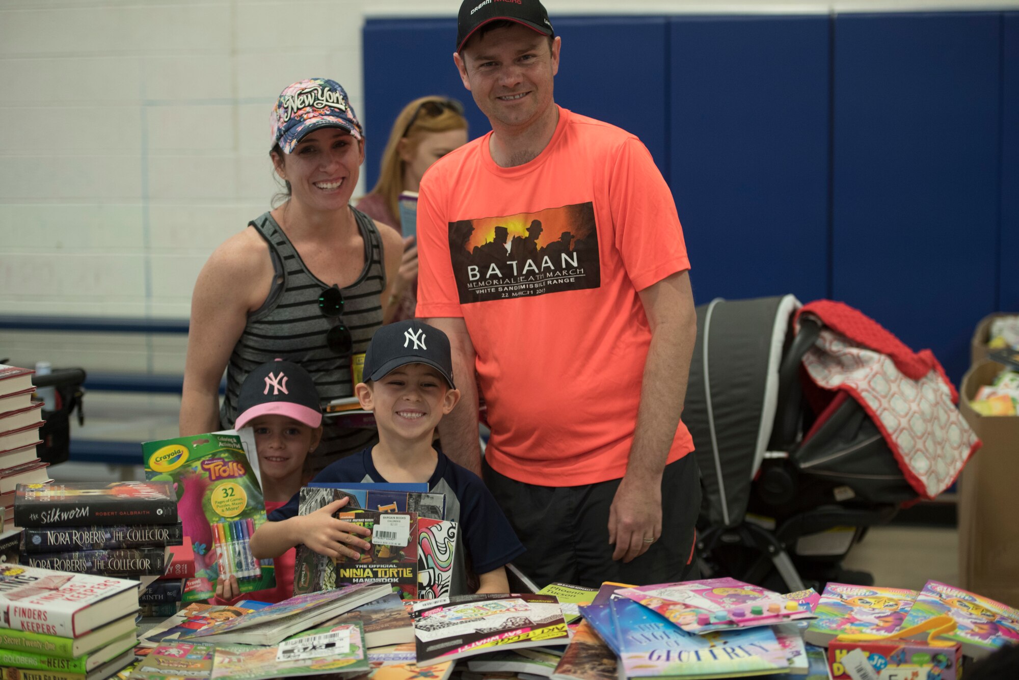 A Family poses during the children’s carnival on Holloman Air Force Base, April 6, 2019. Six thousand books were given out during the event. (U.S. Air Force Photo by Staff Sgt. Timothy Young)