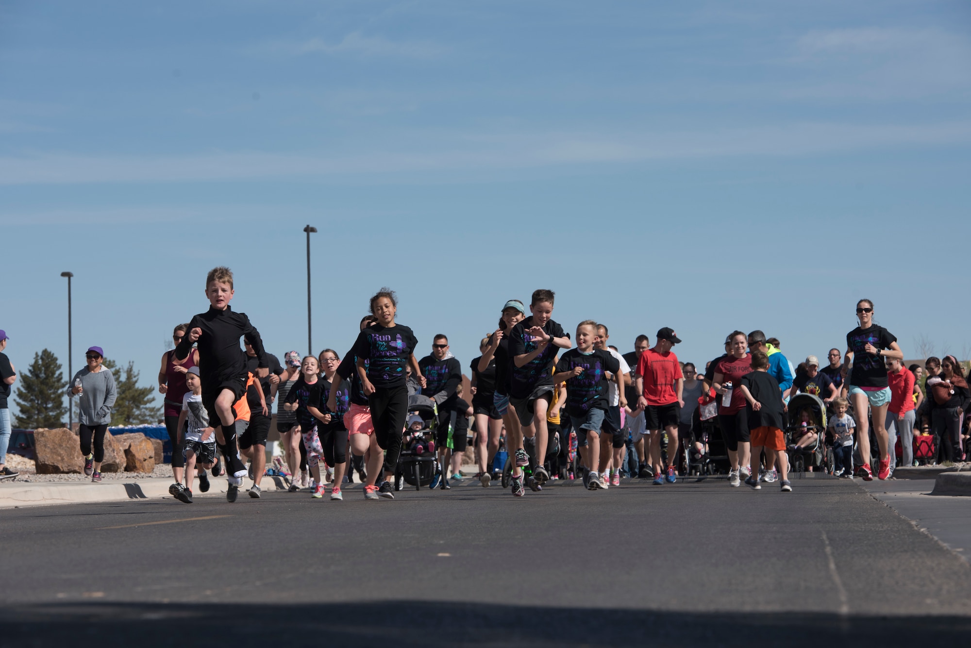 Participates take off from the starting line of an Autism Awareness fun run on Holloman Air Force Base, April 6, 2019. Over 750 people participated in the fun run and children’s carnival. (U.S. Air Force Photo by Staff Sgt. Timothy Young)