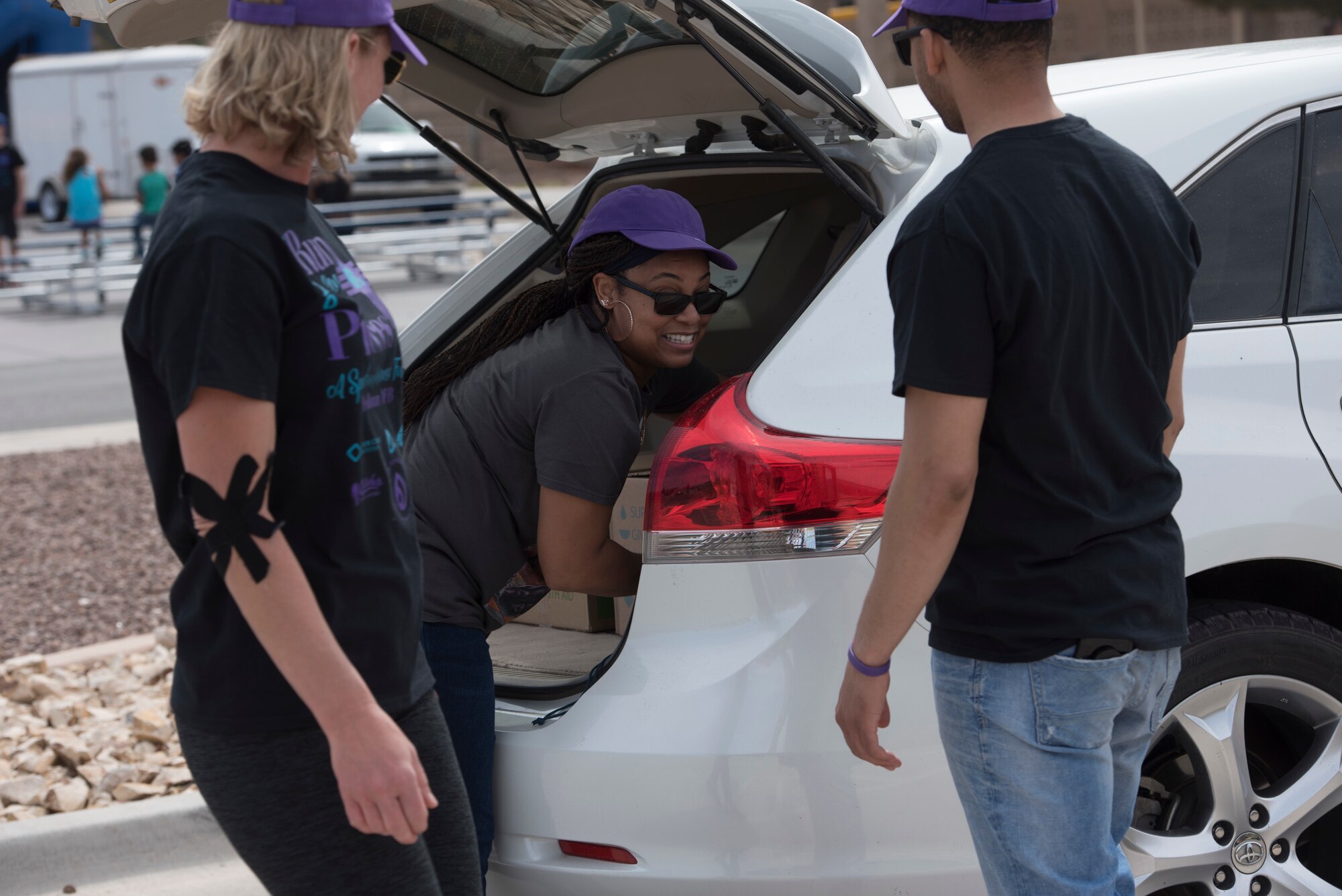 Volunteers place boxes of food in a vehicle during a food donation on Holloman Air Force Base, April 6, 2019. Eight hundred boxes of food and supplies were given out to Holloman families. (U.S. Air Force Photo by Staff Sgt. Timothy Young)