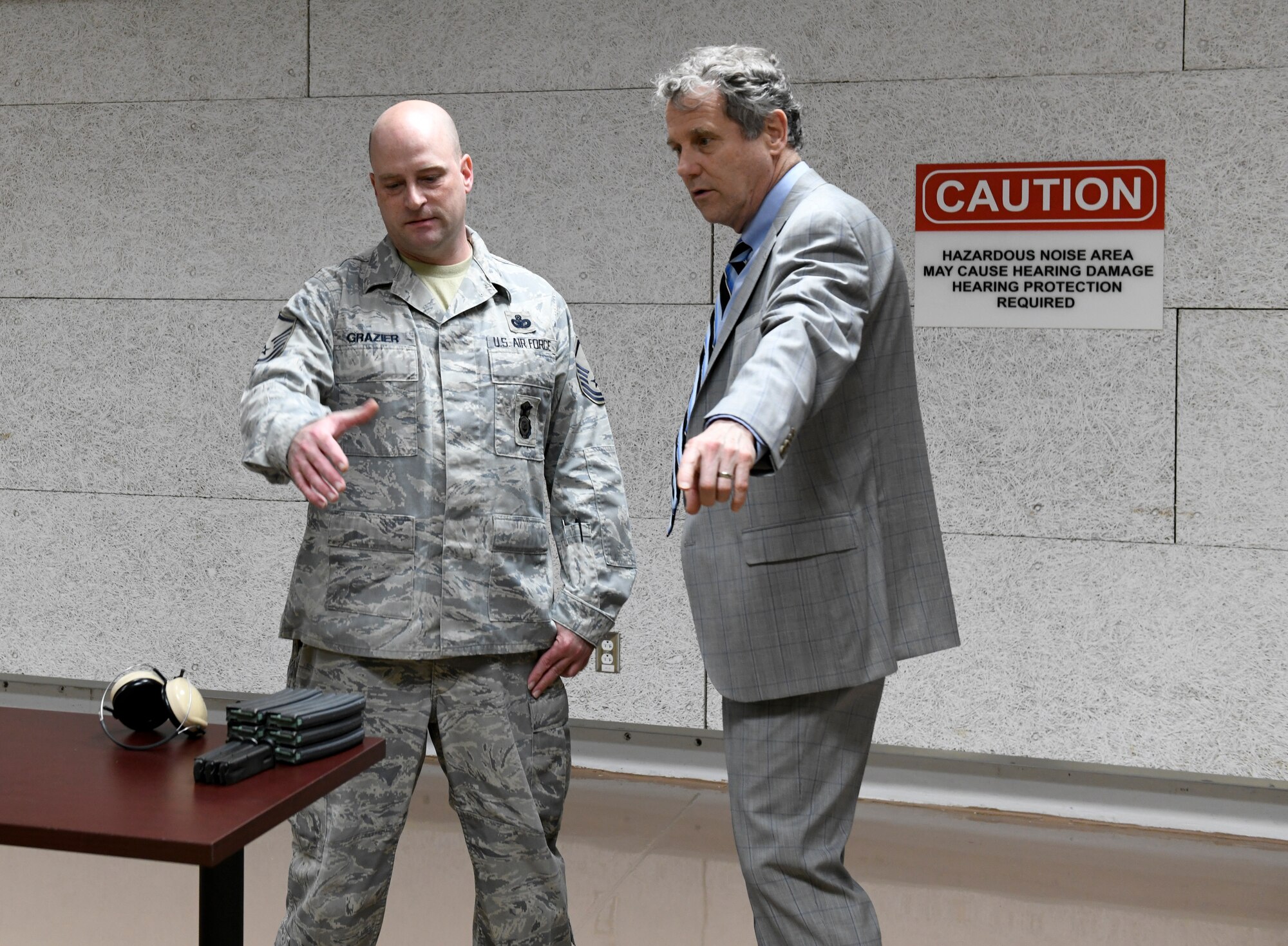 Master Sgt. Brody Grazier (left), combat arms training and maintenance program manager assigned to the 910th Security Forces Squadron, answers questions from Ohio U.S. Sen. Sherrod Brown (right), about various functions of the new state-of-the-art indoor firing range, on April 16, 2019 here.