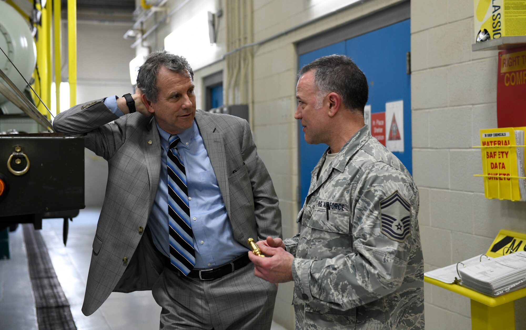 Ohio U.S. Sen. Sherrod Brown, (left) listens to Master Sgt. Phil Aliberti, (right) a spray maintenance supervisor assigned to the 910th Maintenance Squadron, explain the function of an aerial spray nozzle here, April 16, 2019.