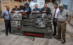 From left to right: Armen Kvryan, Michael Jastrzembski, Tim Tenopir, Keith Sanders, Scott Sanders, Zachary Stephens, and James Powers in front of Lathe, one of the many pieces of equipment used for research and prototype fabrication.