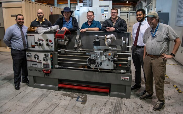 From left to right: Armen Kvryan, Michael Jastrzembski, Tim Tenopir, Keith Sanders, Scott Sanders, Zachary Stephens, and James Powers in front of Lathe, one of the many pieces of equipment used for research and prototype fabrication.