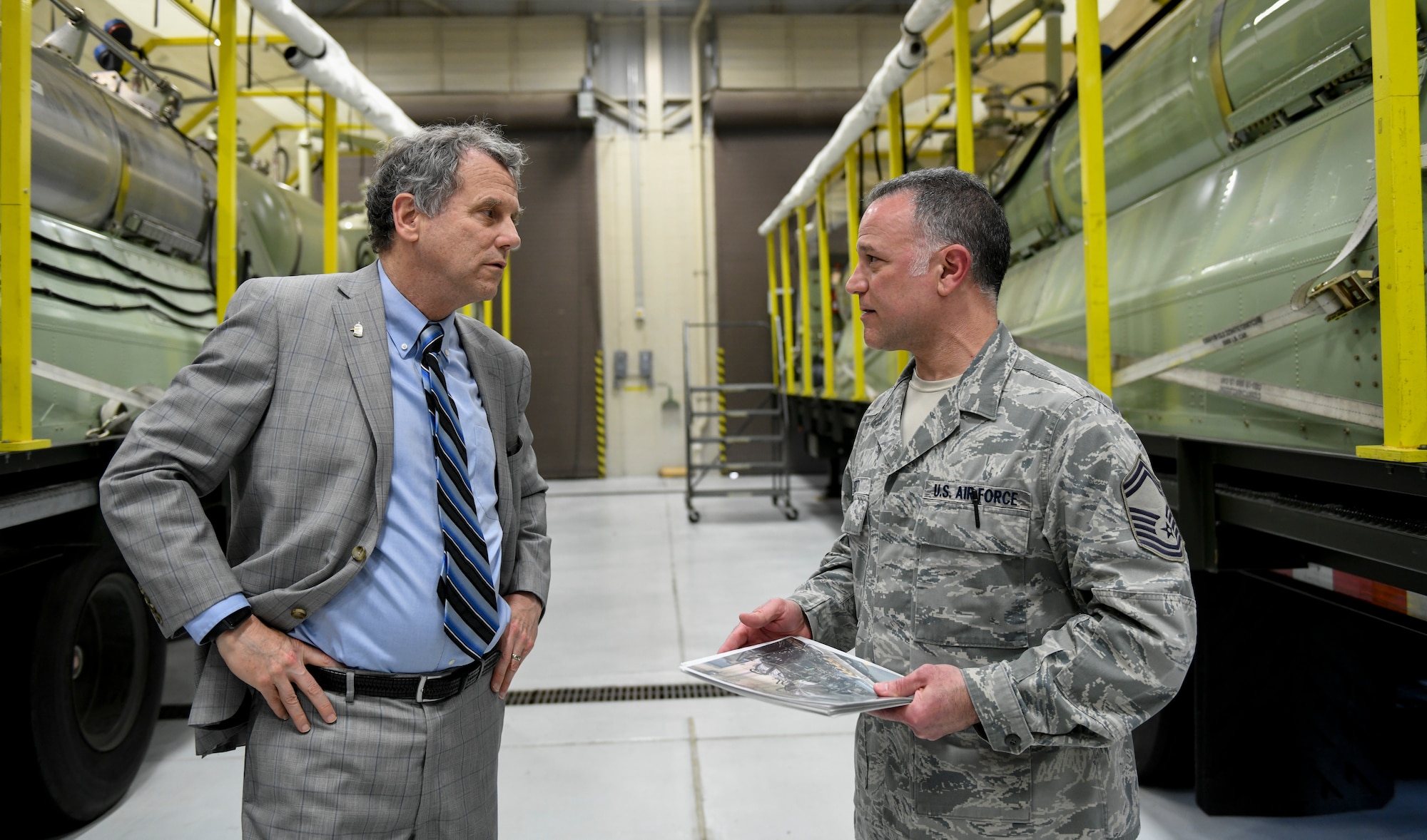 Ohio U.S. Sen. Sherrod Brown, (left) discusses plans for the Modular Aerial Spray System 2.0 with Master Sgt. Phil Aliberti, (right) a spray maintenance supervisor, assigned to the 910th Maintenance Squadron on April 16, 2019, here.