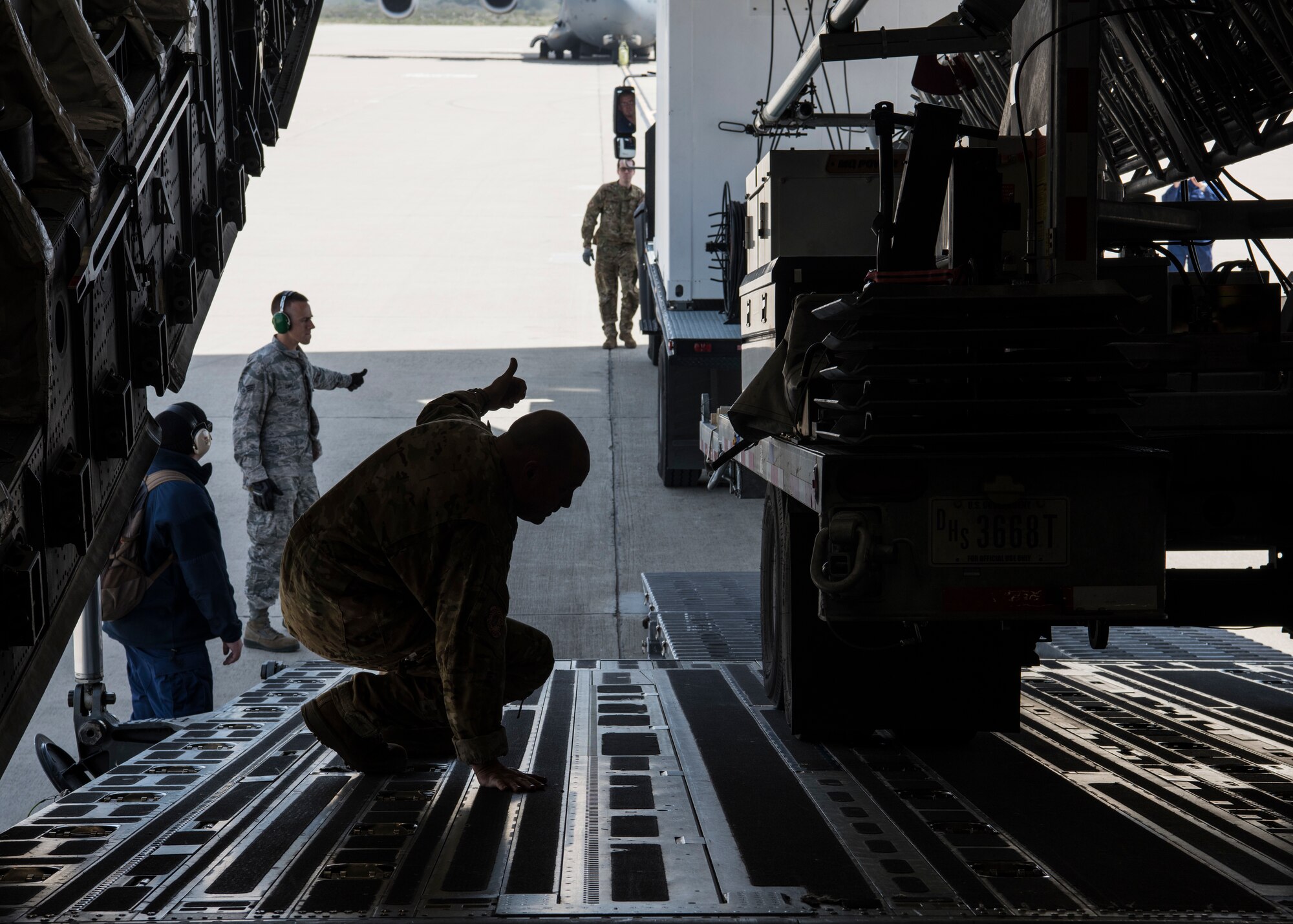 Tech. Sgt. Rodney Bennett, 89th Airlift Squadron loadmaster, secures a vehicle in a C-17 Globemaster III, assigned to Wright-Patterson Air Force Base, Ohio, during exercise Patriot Hook 2019, April 11, 2019, at Vandenberg Air Force Base, Calif. During the exercise, members from different branches teamed-up to train and fine tune procedures, improving deployment processes for during a regional and national disasters at a moment’s notice. (U.S. Air Force photo by Airman 1st Class Aubree Milks)