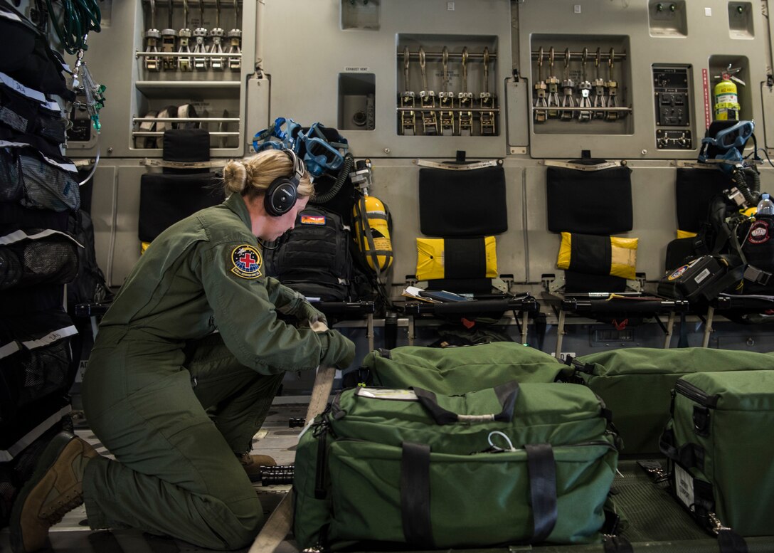 Tech. Sgt. Lindsee Beasley, 42th Air Mobility Wing medical technician, prepares for flight on a C-17 Globemaster III, assigned to Wright-Patterson Air Force Base, Ohio, during exercise Patriot Hook 2019, April 11, 2019, at Vandenberg Air Force Base, Calif. Patriot Hook is an annual joint-service exercise coordinated by the Air Force Reserve Command, designed to integrate the military and first responders of federal, state and local agencies. The exercise provides training for mobilizing quickly and deploying in military aircraft in the event of a regional emergency or natural disaster. (U.S. Air Force photo by Airman 1st Class Aubree Milks)