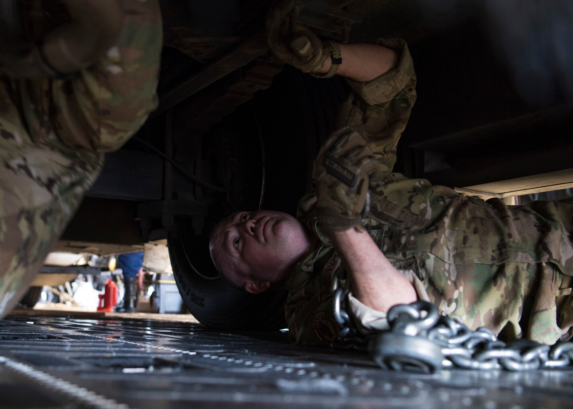 Tech. Sgt. Rodney Bennett, 89th Airlift Squadron loadmaster, secures a vehicle in a C-17 Globemaster III, assigned to Wright-Patterson Air Force Base, Ohio, during exercise Patriot Hook 2019, April 11, 2019, at Vandenberg Air Force Base, Calif. During the exercise, external players from Air Force Reserve Command, as well as Army Reserve and Coast Guard, tested their rapid disaster and medical response skills. Crewmembers, airfield managers, aerial porters and loadmasters aided in the movement of equipment and prepared cargo for a mock deployment. (U.S. Air Force photo by Airman 1st Class Aubree Milks)