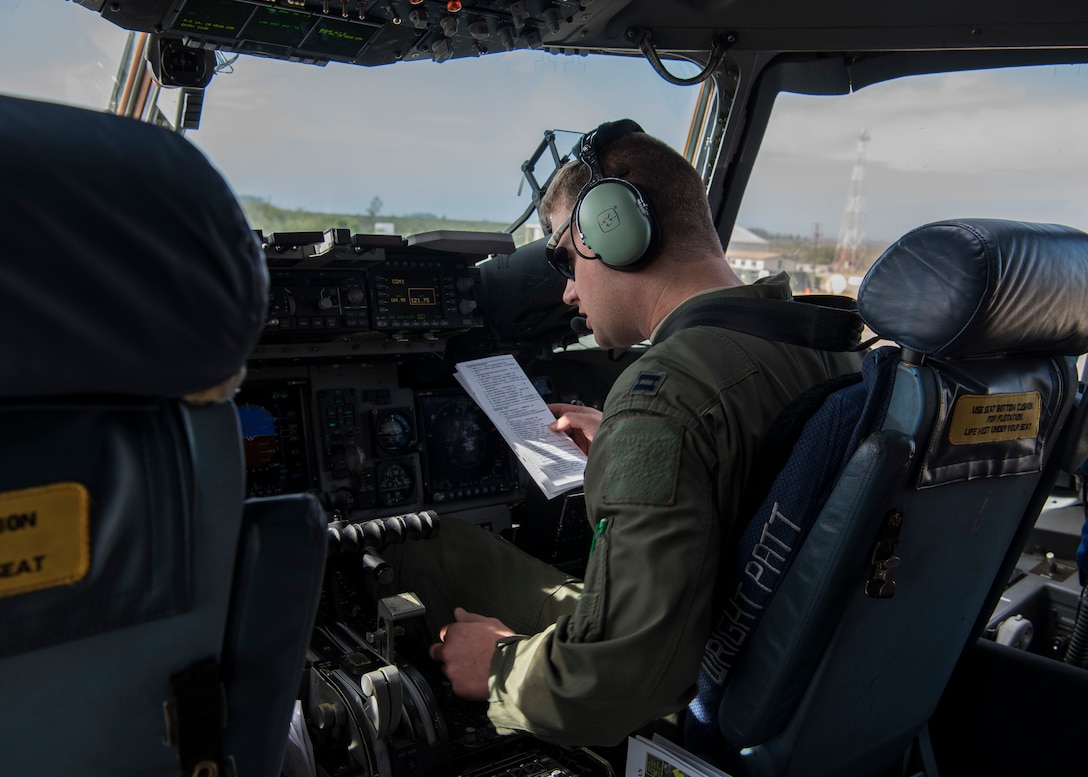 Capt. Jeremiah Brown, 89th Airlift Squadron pilot, runs through a preflight checklist in a C-17 Globemaster III, assigned to Wright-Patterson Air Force Base, Ohio, during exercise Patriot Hook 2019, April 11, 2019, at Vandenberg Air Force Base, Calif. The exercise was designed to integrate different branches of the military and first responders of federal, state and local agencies. They train for real-world situations where they would need to mobilize quickly and deploy military aircraft, in the event of a regional emergency or natural disaster. (U.S. Air Force photo by Airman 1st Class Aubree Milks)