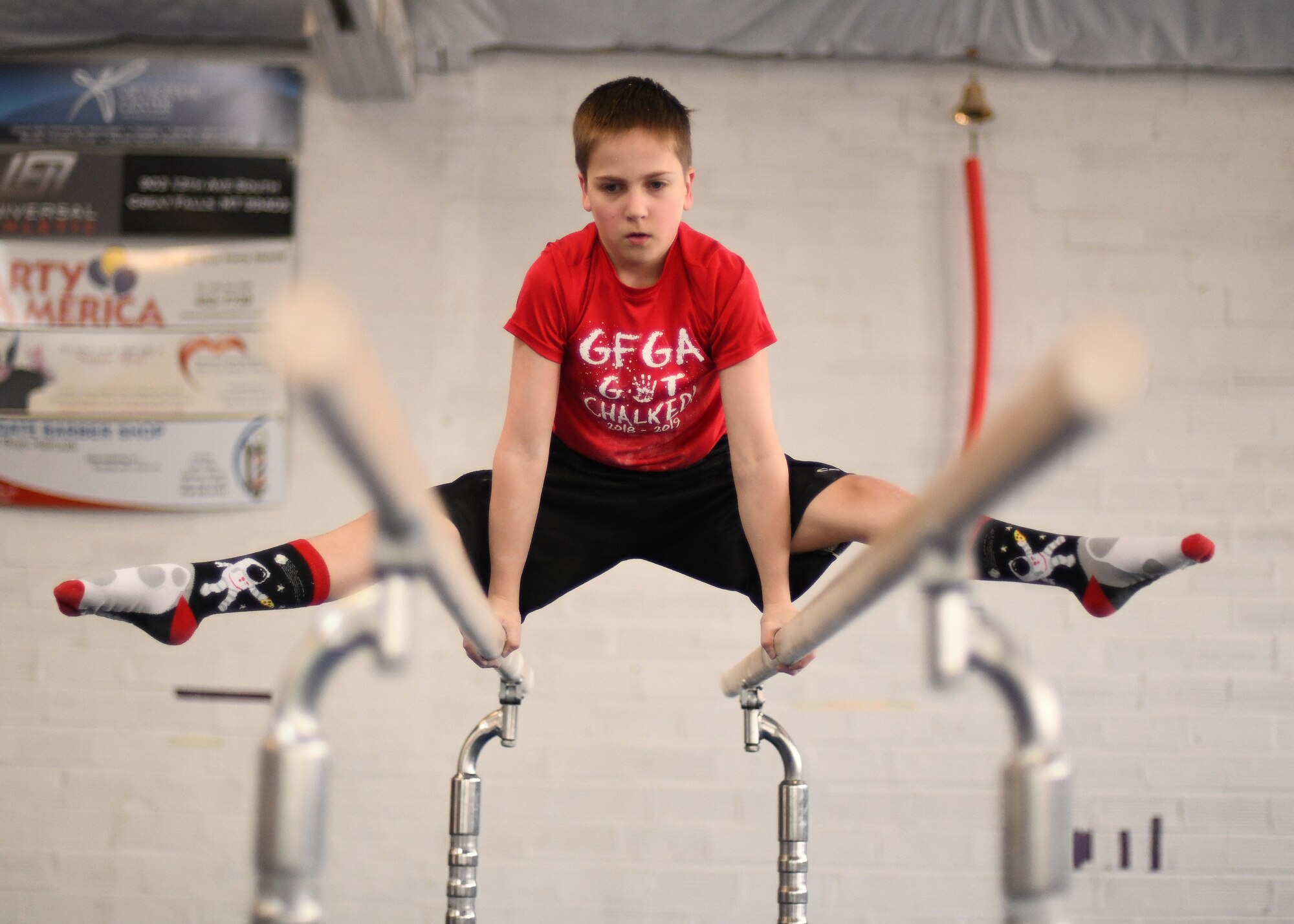 Jonathan Menuey, son of Col. Christopher Menuey, 341st Operations Group, practices his routine on parallel bars April 11, 2019, in Great Falls, Mont.