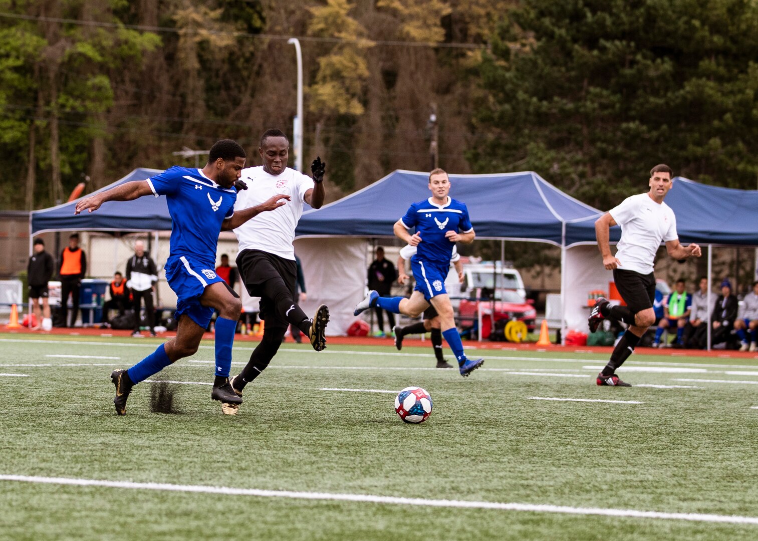 NAVAL STATION EVERETT, Wa. (April 16, 2019) - Players for the Air Force soccer compete for the ball against players from Marine Corp soccer team during a second round match of the Armed Forces Sports Men’s Soccer Championship hosted at Naval Station Everett. (U.S. Navy Photo by Mass Communication Specialist 2nd Class Ian Carver/RELEASED).