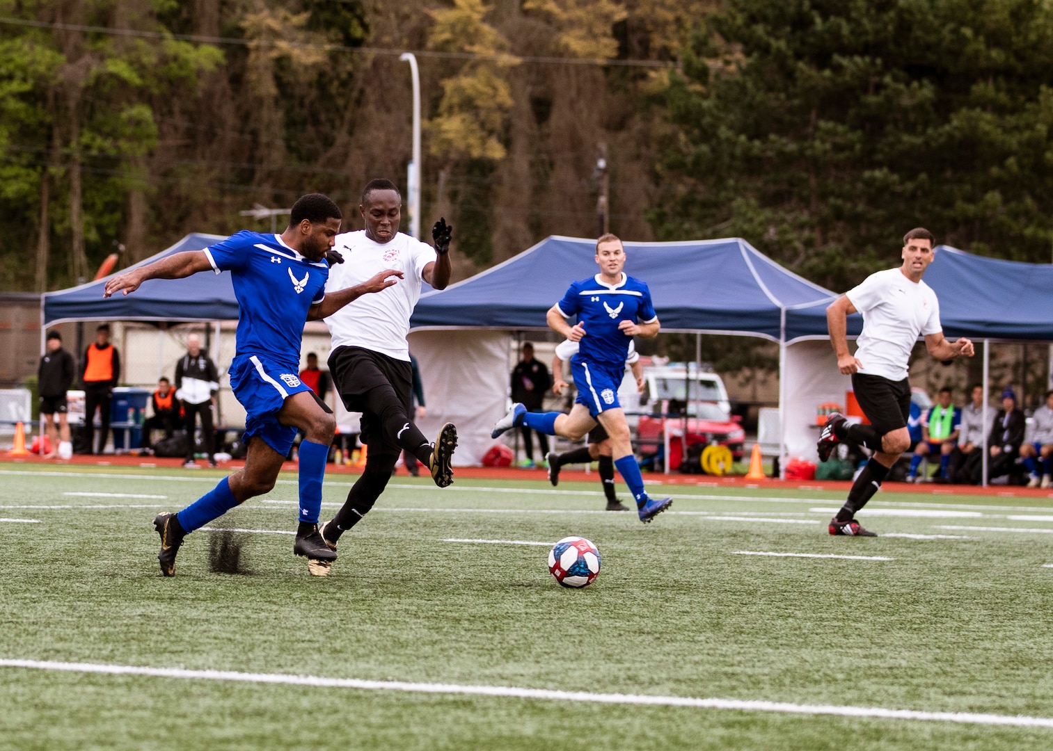 NAVAL STATION EVERETT, Wa. (April 16, 2019) - Players for the Air Force soccer compete for the ball against players from Marine Corp soccer team during a second round match of the Armed Forces Sports Men’s Soccer Championship hosted at Naval Station Everett. (U.S. Navy Photo by Mass Communication Specialist 2nd Class Ian Carver/RELEASED).