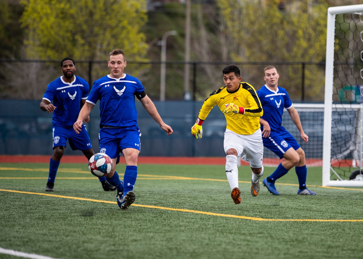 NAVAL STATION EVERETT, Wa. (April 16, 2019) - Sgt. Mark Cambron, stationed at Marine Corp Base Camp Pendleton, Ca., of the Marine Corp soccer team runs to defend a goal attemp by players on the Air Force soccer team during a second round match of the Armed Forces Sports Men’s Soccer Championship hosted at Naval Station Everett. (U.S. Navy Photo by Mass Communication Specialist 2nd Class Ian Carver/RELEASED).