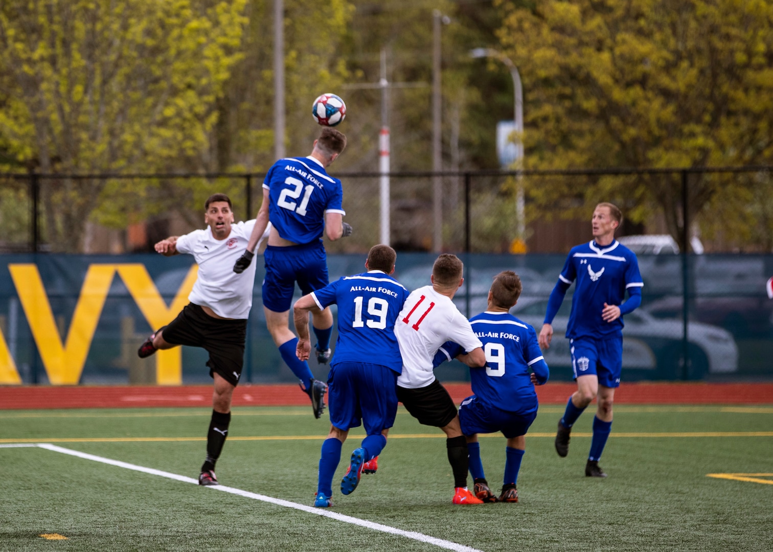 NAVAL STATION EVERETT, Wa. (April 16, 2019) - Airman 1st Class Austin Spagnola, stationed at Joint Base Lewis McChord, Wa., from the Air Force soccer team heads a ball away from players from the Marine Corp soccer team during a second round match of the Armed Forces Sports Men’s Soccer Championship hosted at Naval Station Everett. (U.S. Navy Photo by Mass Communication Specialist 2nd Class Ian Carver/RELEASED).