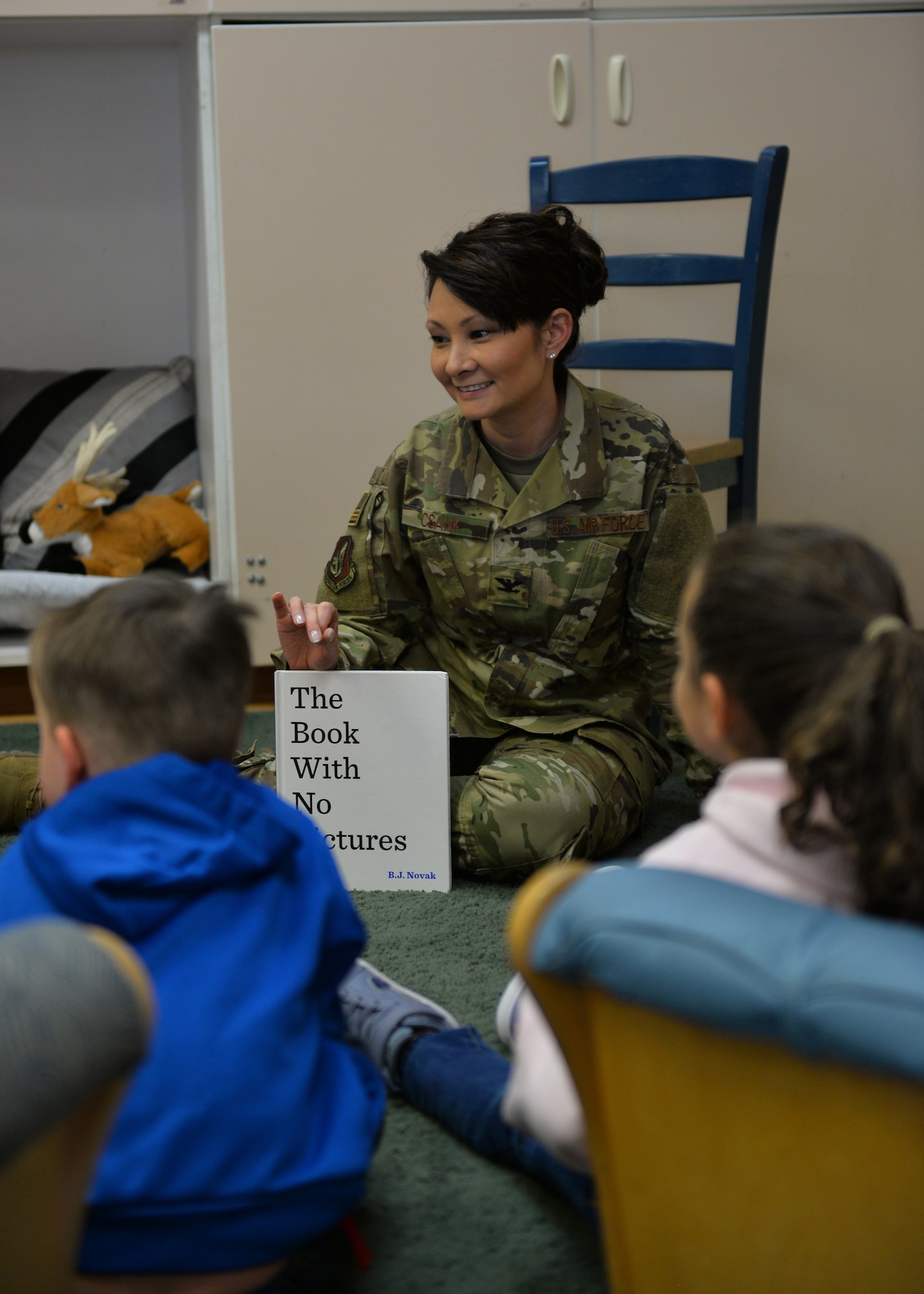 U.S. Air Force Col. Patricia Csànk, Joint Base Elmendorf-Richardson and 673d Air Base Wing commander, interacts with kids at the Denali Child Development Center, JBER, Alaska, April 8, 2019. In honor of Month of the Military Child, Csànk visited the Denali Child Development Center at JBER to read to some of the children. Out of the selection of four books, the kids elected to read “The Book With No Pictures,” by B.J. Novak, knowing all too well what this piece of literature would have Csànk reading aloud.