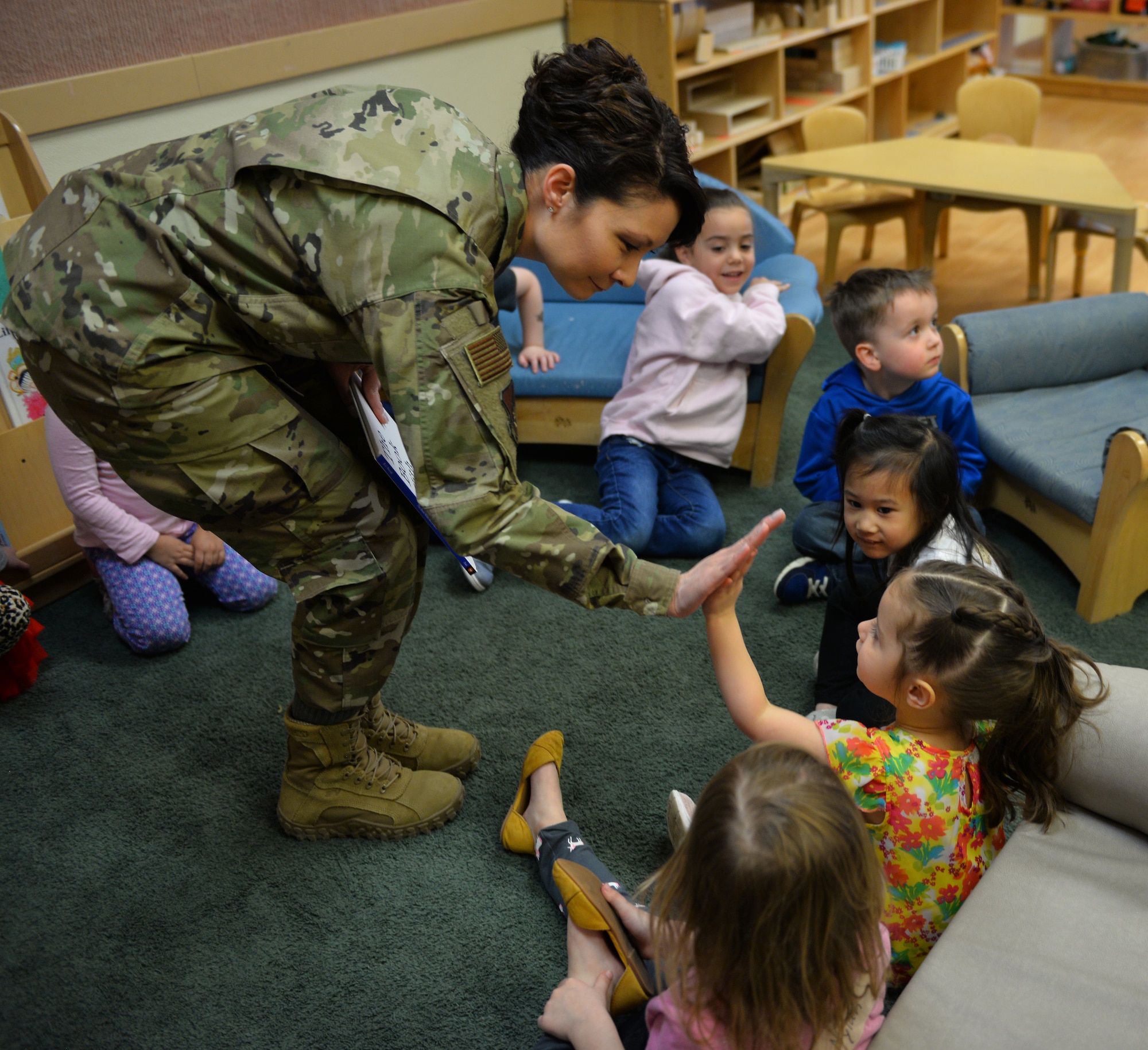 U.S. Air Force Col. Patricia Csànk, Joint Base Elmendorf-Richardson and 673d Air Base Wing commander, says goodbye to kids at the Denali Child Development Center April 8, 2019, at JBER, Alaska. In honor of Month of the Military Child, Csànk visited the Denali Child Development Center at JBER to read to some of the children. Out the selection of four books, the kids elected to read “The Book With No Pictures,” by B.J. Novak, knowing all too well what this piece of literature would have Csànk reading aloud.