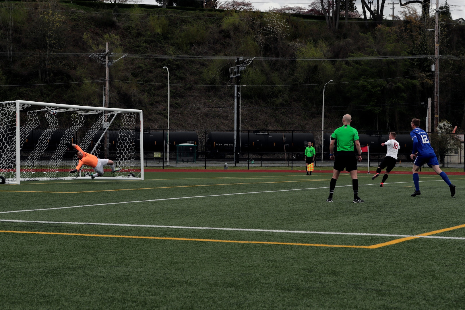 NAVAL STATION EVERETT, Wash.  (April 14, 2019) Marine Lance Corporal Nicholas Heath (#18) of MCB Camp Lejeune, N.C. scores on the penalty kick, registering his second goal of the match and third of the tournament against Air Force during the 2019 Armed Forces Men's Soccer Championship held at Naval Station Everett, Wash. from 14-20 April, featuring Service members from the Army, Marine Corps, Navy (including Coast Guard) and Air Force. (U.S. Navy photo by MC2 Ian Carver/Released)