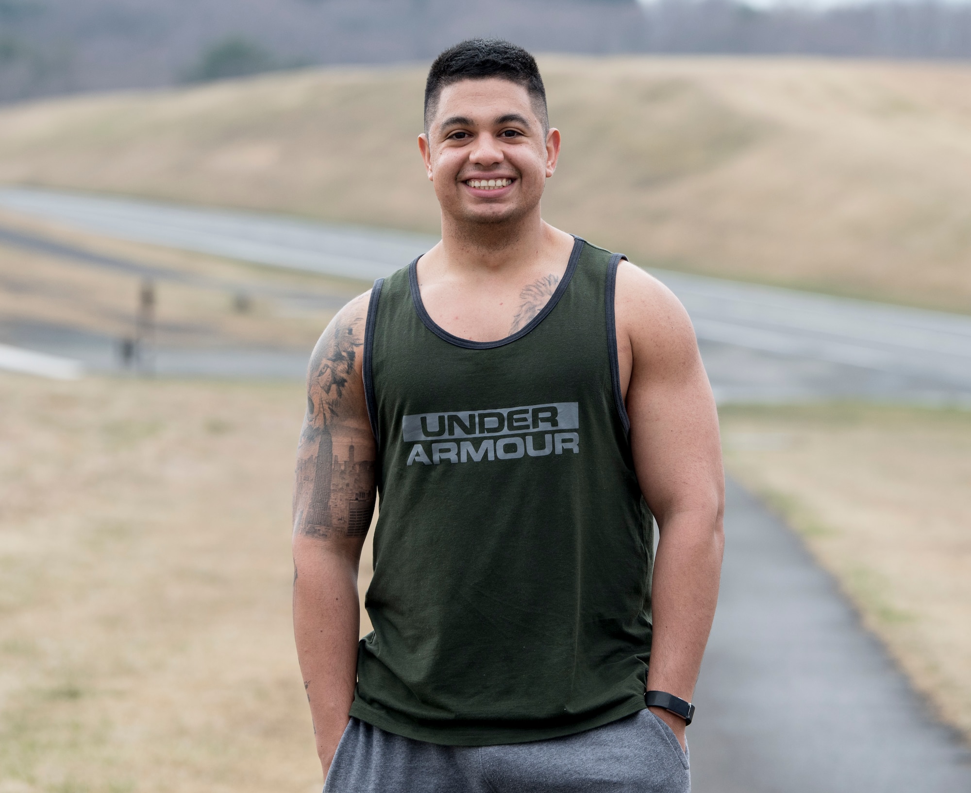 U.S. Air Force 1st Lt. Jeremy E. Garcia, a 35th Fighter Wing public affairs officer, smiles for the camera before he begins his 5-mile run through Misawa Air Base. He began running to redefine his identity and turn himself into a better leader for his Airmen. He used running as a tool to develop mental resiliency. (U.S. Air Force photo by Staff Sgt. Brittany A. Chase)