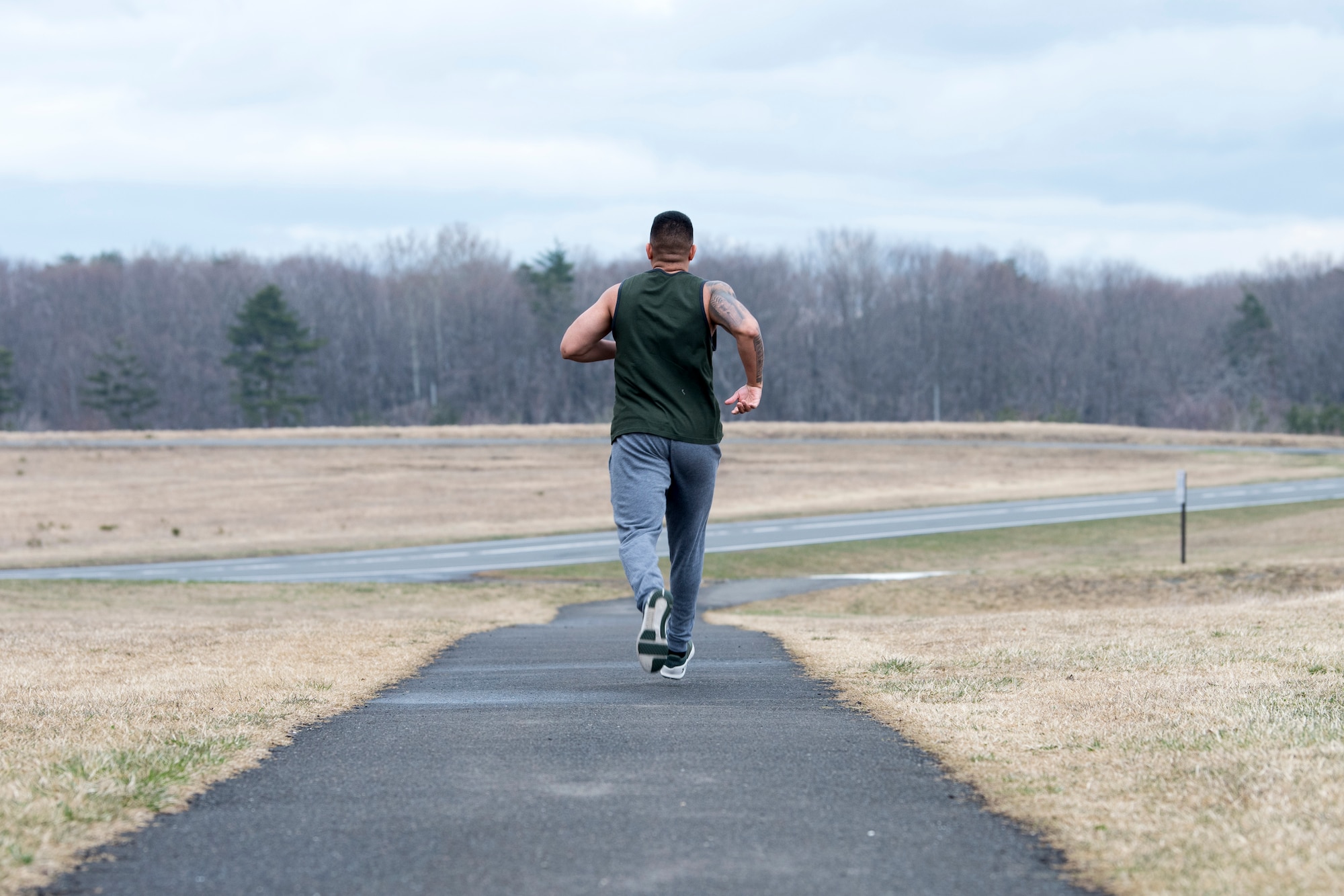 U.S. Air Force 1st Lt. Jeremy E. Garcia, a 35th Fighter Wing public affairs officer, begins his run across Misawa Air Base to continue to lose weight and develop mental resiliency. He began running to redefine his identity and turn himself into a better leader for his Airmen.  (U.S. Air Force photo by Staff Sgt. Brittany A. Chase)