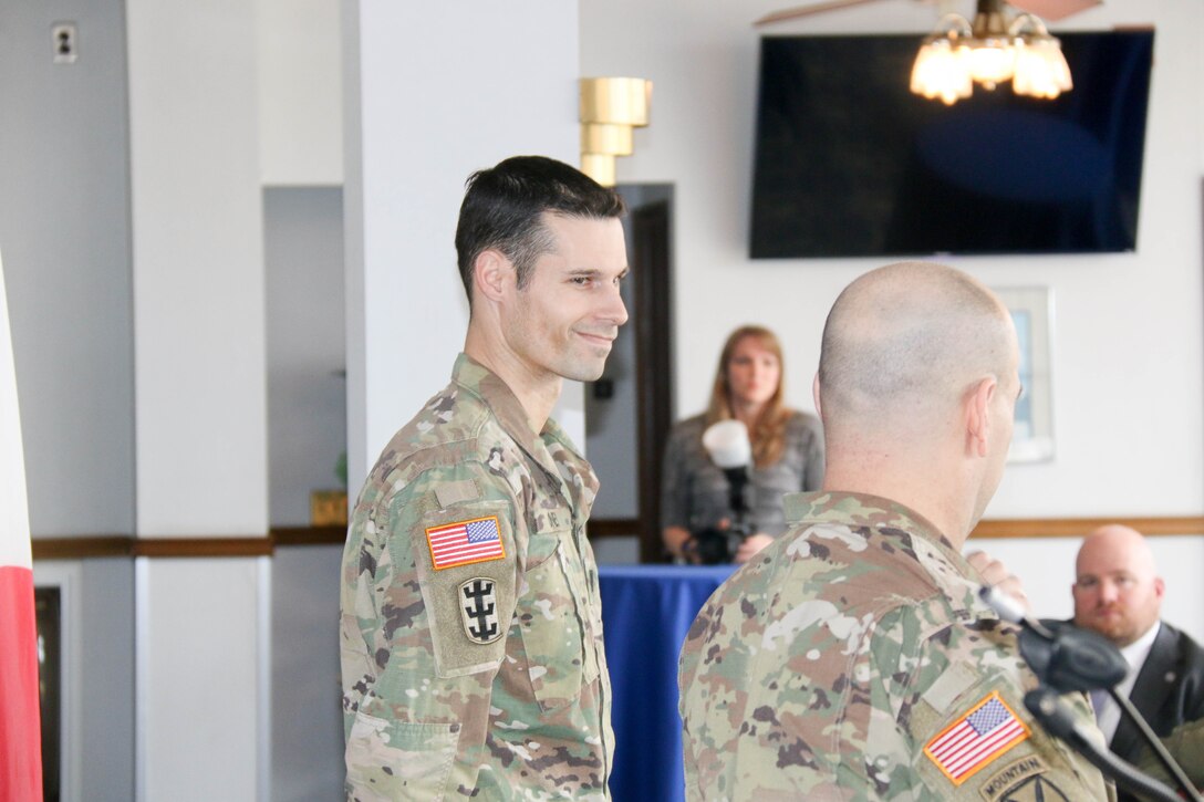 Capt. Taylor Oney listens to the opening remarks from Japan Engineer District Commander Col. Thomas J. Verell, Jr. during his promotion ceremony to Major.