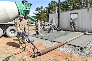 Members from the 176th Civil Engineer Squadron, Joint Base Elmendorf-Richardson, Alaska, create a concrete pad for the 8th Civil Engineer Squadron at Kunsan Air Base, Republic of Korea, April 17, 2019. The 176th CES sent members on a training deployment to gain experience performing tasks they normally wouldn’t have an opportunity to back at their home station. (U.S. Air Force photo by Senior Airman Stefan Alvarez)