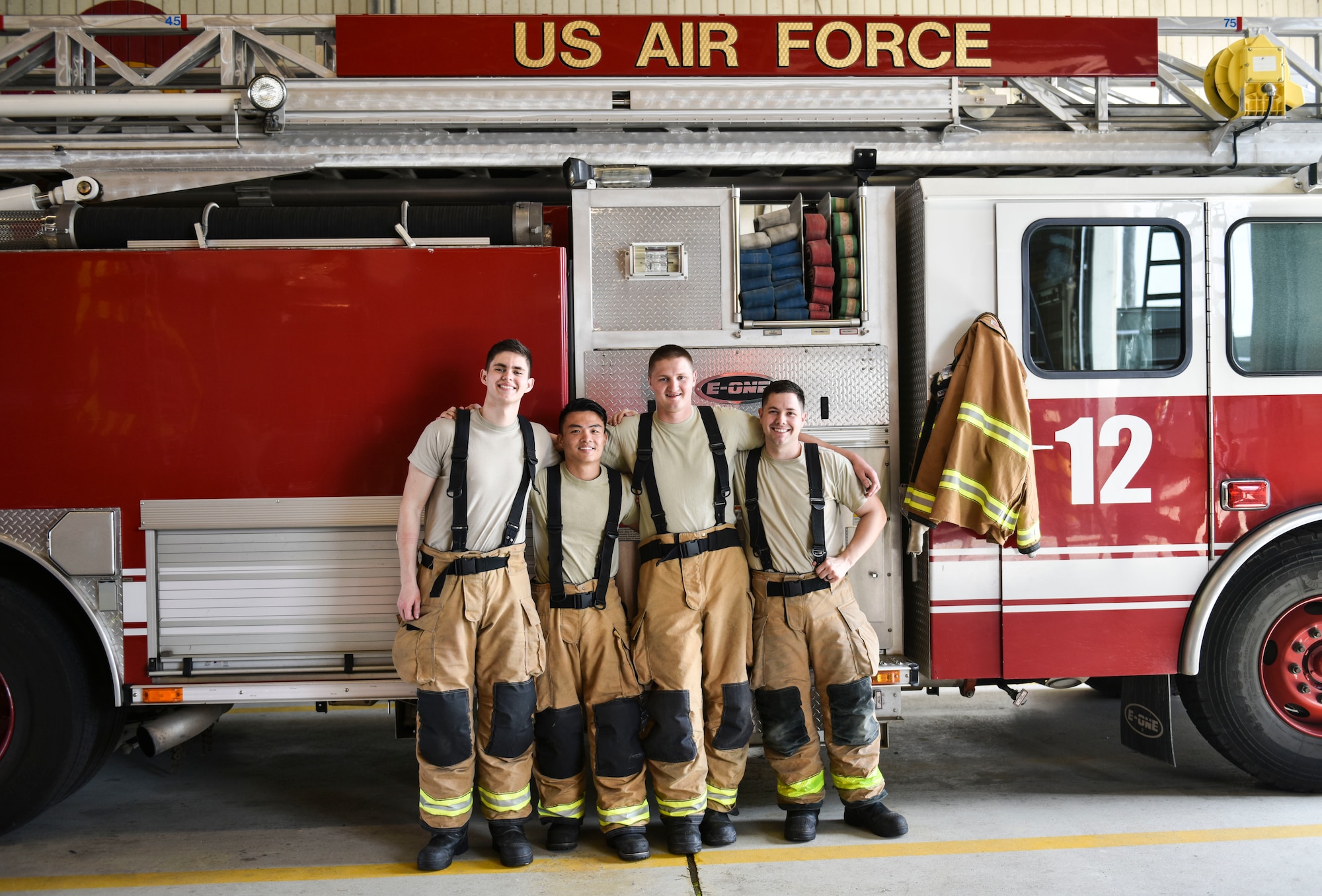 U.S. Air Force Tech. Sgt. Tyler Larimer (second from right), a firefighter from the 176th Civil Engineer Squadron, Joint Base Elmendorf-Richardson, Alaska, poses for a photo with 8th Civil Engineer Squadron firefighters at Kunsan Air Base, Republic of Korea, April 17, 2019. Larimer immersed himself with the 8th CES fire department and responded to several calls, gaining experience on flight line and aircraft fire operations. (U.S. Air Force photo by Senior Airman Stefan Alvarez)