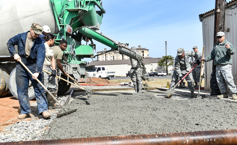 Members from the 176th Civil Engineer Squadron, Joint Base Elmendorf-Richardson, Alaska, create a concrete pad for the 8th Civil Engineer Squadron at Kunsan Air Base, Republic of Korea, April 17, 2019. The 176th CES sent members on a training deployment to assist the 8th CES in fulfilling work orders around the installation. (U.S. Air Force photo by Senior Airman Stefan Alvarez)