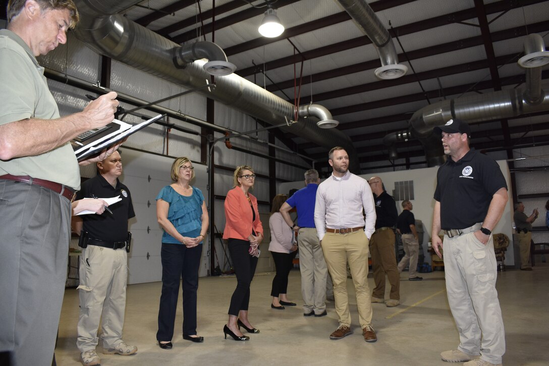 Casey Ford, Transportation Security Administration trainer, talks to members of the government-wide working dog team about the TSA’s canine training center on JBSA-Lackland, Texas, April 17, 2019. TSA trainers provide, train and certify highly effective explosives detection canine teams at the center. (U.S. Air Force photo by Shannon Carabajal)