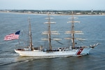 oast Guard Cutter Eagle transits down the Savannah River towards Savannah, Georgia, Mar. 15, 2019, in front of the Tybee Island Lighthouse. The Eagle arrived in Savannah for St. Patrick’s Day weekend with over 100 guests on board.