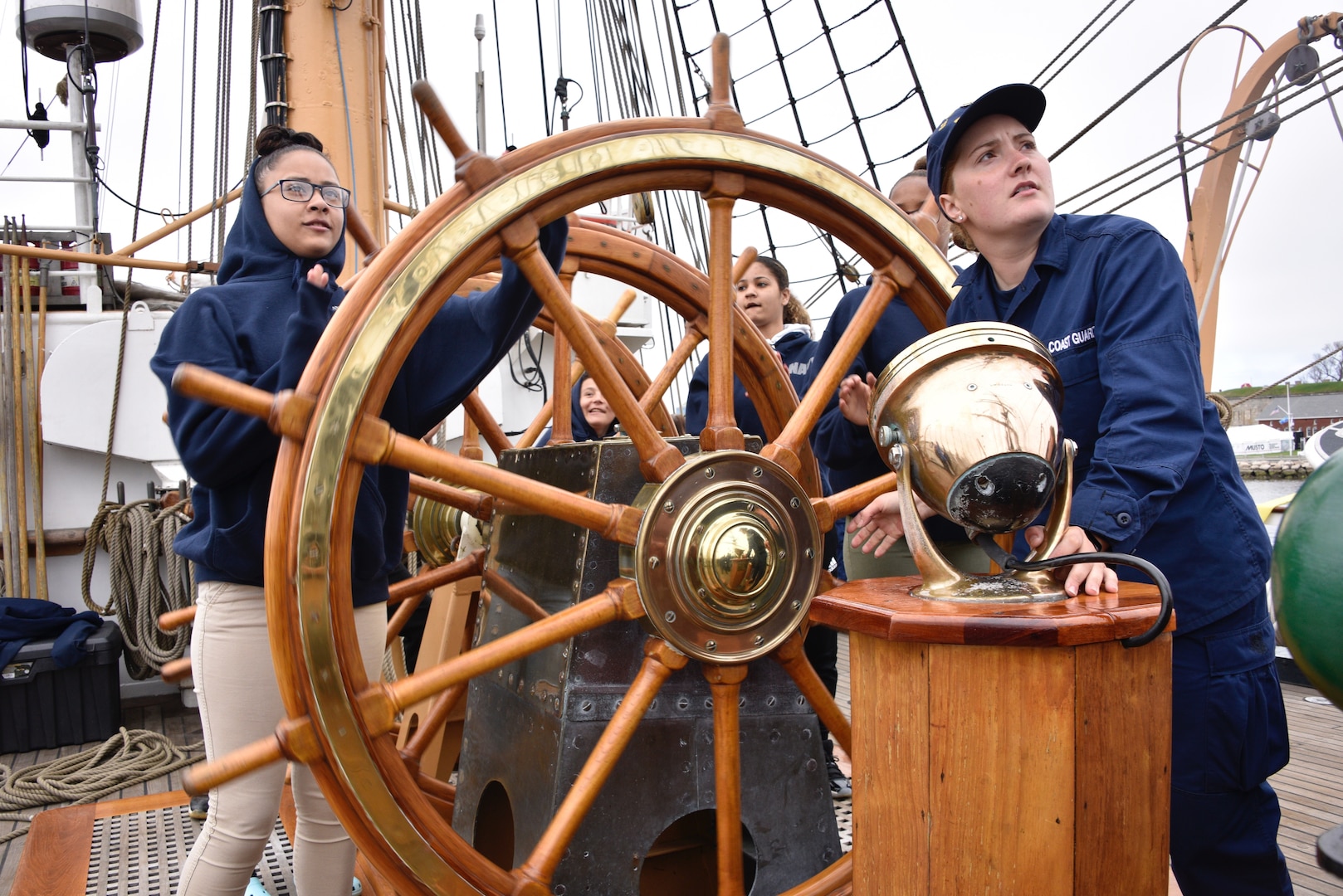 Students from the New London High School ROTC help steer the Coast Guard Cutter Barque Eagle May 10, 2018. The cutter is about underway to New London, Connecticut with members of the Coast Guard Foundation, Coast Guard Academy, New London Rotary Club and students in the New London High School Navy ROTC.