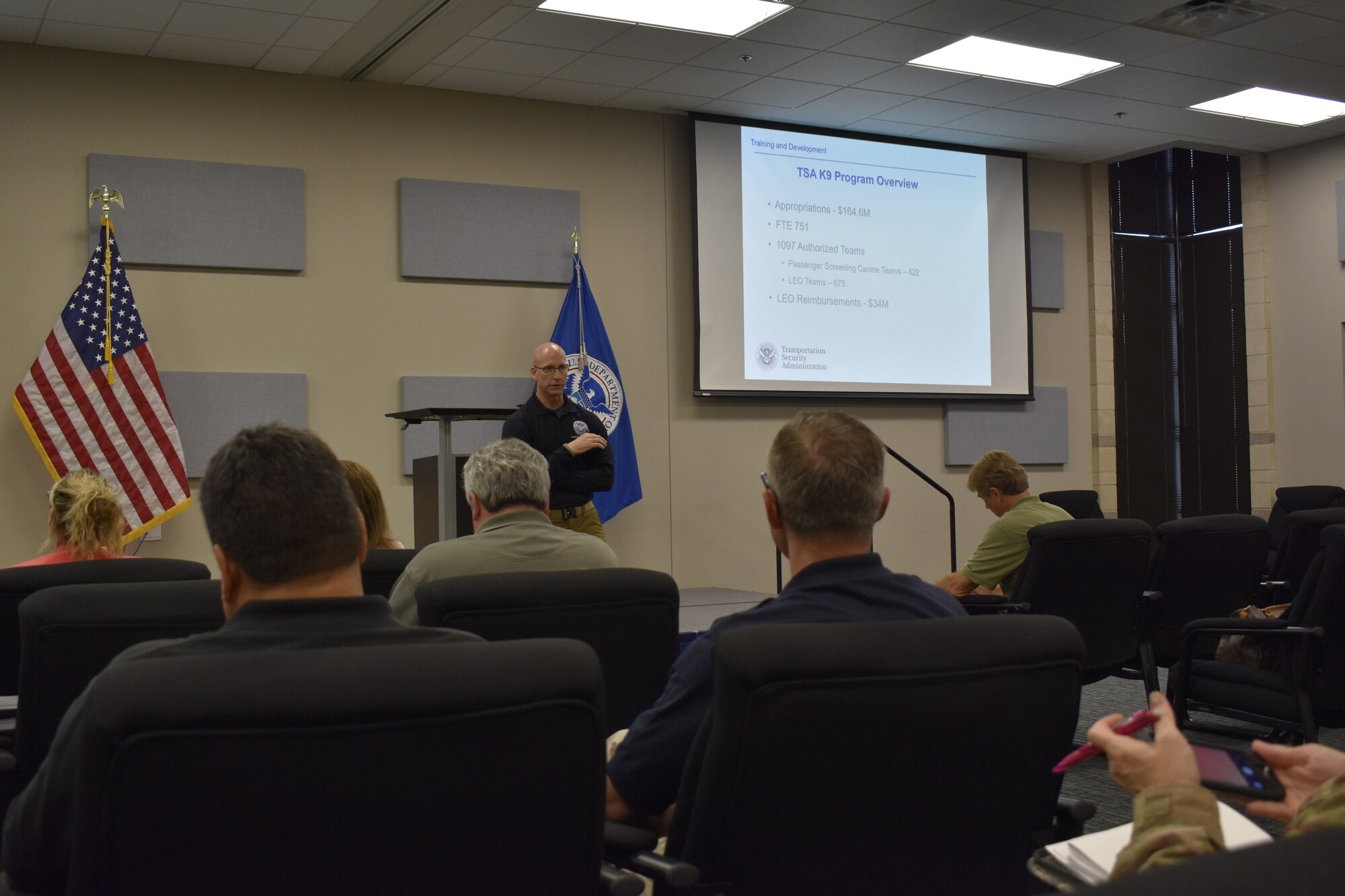 Chris Shelton, branch manager of the Transportation Security Administration’s JBSA-Lackland Canine Training Center, talks to members of the government-wide working dog team about the center’s mission April 17, 2019. The center trains and deploys both TSA-led and state and local law enforcement-led canine teams in support of day-to-day activities that protect the transportation domain and provide a visible deterrent to terrorism. (U.S. Air Force photo by Shannon Carabajal)