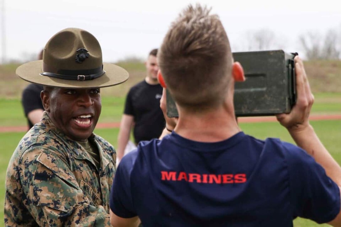 Sergeant Kevin Williams, a drill instructor with Marine Corps Recruit Depot San Diego, California, instructs a poolee how to properly lift ammo cans during the combat fitness test at an all-hands pool function. Recruiting Station Indianapolis hosted the pool function to simulate recruit training, while preparing  the poolees to deal with the stress and high tempo during the 13-week training regimen. (Official U.S. Marine Corps photo by Sgt. Carl King/Released)