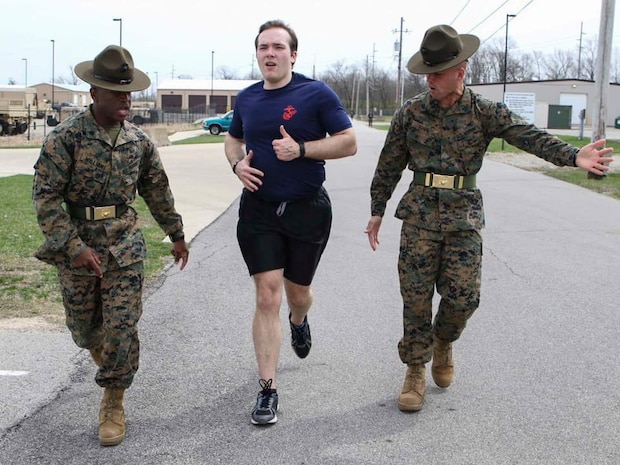 Sergeants Kevin Williams and Matthew Schihl, drill instructors with Marine Corps Recruit Depot San Diego, California, motivate a poolee to run faster during the combat fitness test at an all-hands pool function. Recruiting Station Indianapolis hosted the pool function to simulate recruit training, while preparing  the poolees to deal with the stress and high tempo during the 13-week training regimen. (Official U.S. Marine Corps photo by Sgt. Carl King/Released)