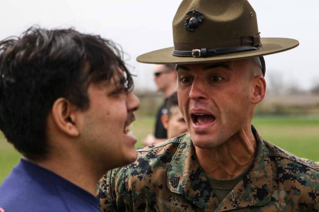 Sergeant Matthew Schihl, a drill instructor with Marine Corps Recruit Depot San Diego, California, motivates a poolee during the combat fitness test at an all-hands pool function. Recruiting Station Indianapolis hosted the pool function to simulate recruit training, while preparing  the poolees to deal with the stress and high tempo during the 13-week training regimen. (Official U.S. Marine Corps photo by Sgt. Carl King/Released)